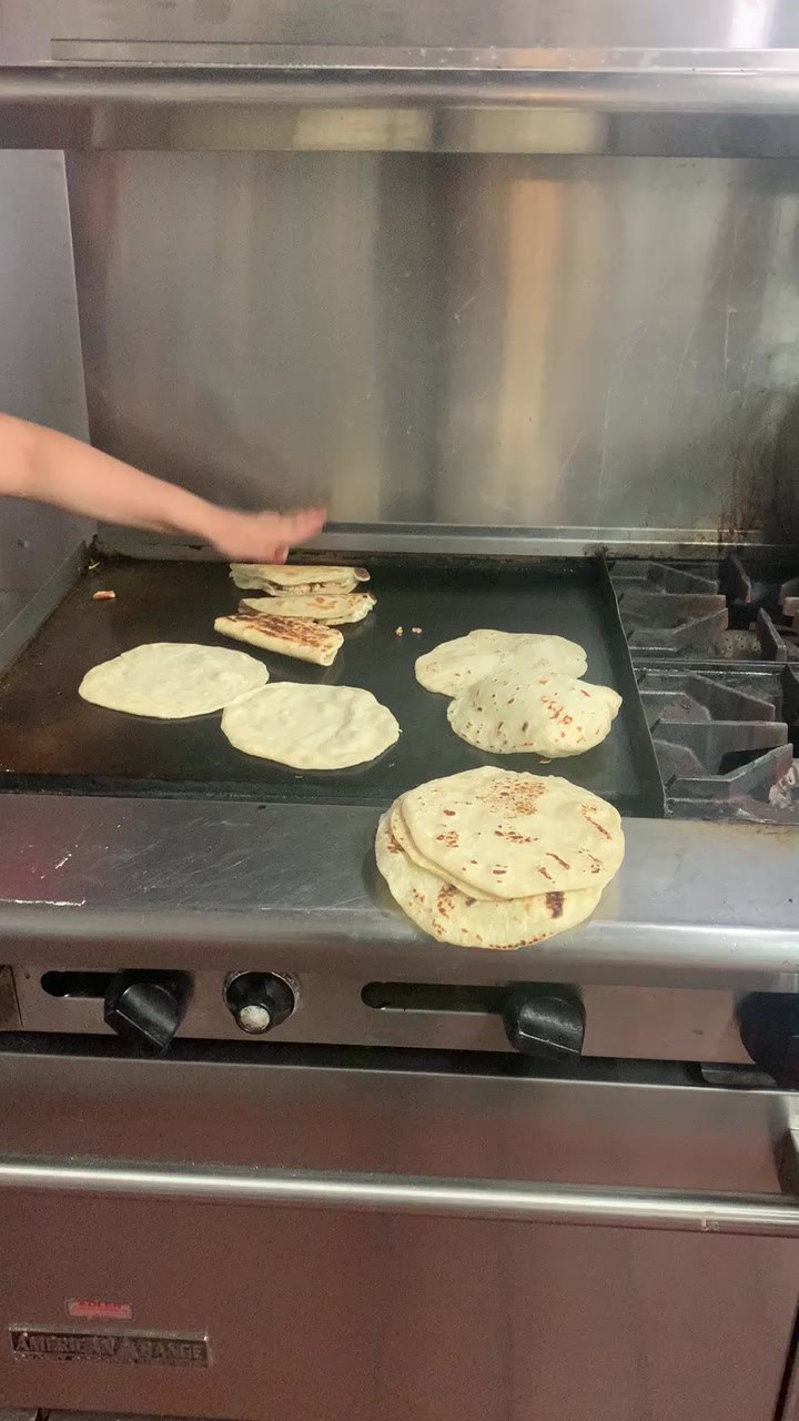 Handmade tortillas cooking on Trigo’s griddle